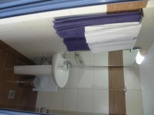 a bathroom with a toilet and towels on the wall at Paraschos Studios Kos in Kardamaina