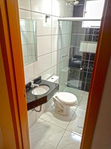 a bathroom with a toilet and a sink and a shower at Hotel Royal Jaraguá in Jaraguá do Sul +15 photos