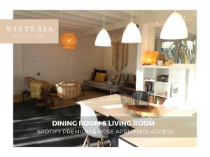 a living room with a dining rooms living room at Wisteria Guest House in Villers-lʼÉvêque