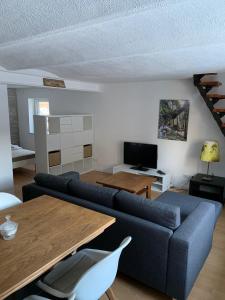 a living room with a blue couch and a table at Ferienwohnung Winterberg Lodge in Winterberg