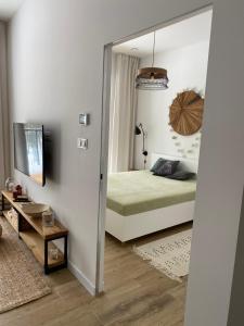 a bedroom with a mirror and a bed in it at Apartament Nieznany Bór in Hajnówka