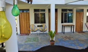 a living room with two chairs and a table at Hotel Pura Natura Beachfront Tortuguero in Tortuguero