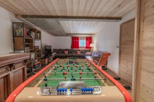 a living room with a ping pong table at Chalet "Le Lorgnon" in La Salle-les-Alpes