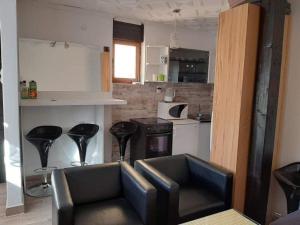 a kitchen with a couch in the middle of a room at Tara Medina koliba in Kaludjerske Bare