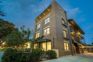 a tall brick building with lights on at Bishop Arts Hotel in Dallas