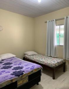 A bed or beds in a room at Peróba Praia Azul