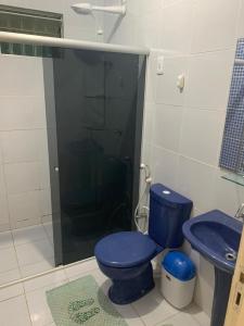 a bathroom with a blue toilet and a sink at Peróba Praia Azul in Maragogi