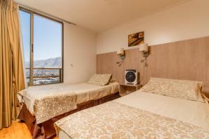 Een bed of bedden in een kamer bij Departamentos Alpro Cavancha