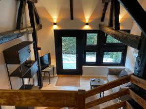an overhead view of a living room with a wooden staircase at Ferienwohnung St. Dionyser Heidedorf in Sankt Dionys