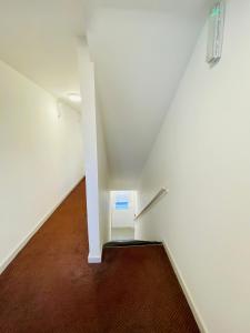 an empty hallway with a stair case in a building at Almond Tree Hotel in Bicester +48 photos