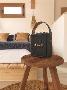 a briefcase sitting on a stool next to a bed at Eco Finca Sa Becadeta in Llucmajor