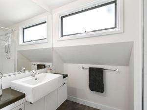 a bathroom with a sink and a window at Point Roadknight Paradise Villa 6 in Anglesea