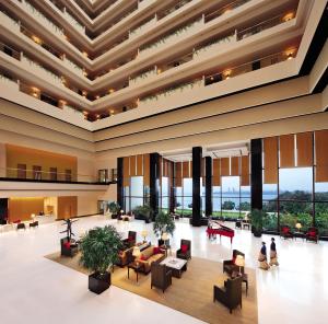 a living room filled with furniture and a large window at The Oberoi Mumbai in Mumbai
