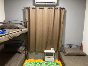 a room with two bunk beds and a window at FAHANAZ RESIDENCE in Melaka +44 photos