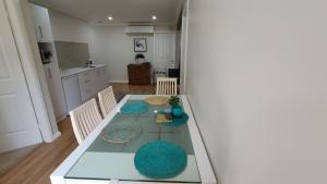 a dining room with a table and chairs in a kitchen at Se-Ayr BnB at Lighthouse in Port Macquarie