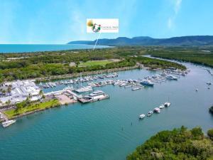 an aerial view of a marina with boats in the water at Lychee Tree Holiday Apartments in Port Douglas