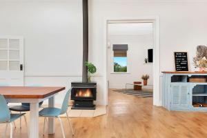 a living room with a table and a fireplace at The River Block in Berri