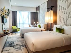 The Excelsior Hotel Las Piñas客房内的一张或多张床位