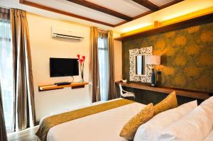 Säng eller sängar i ett rum på Infinity Resort