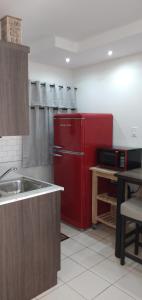 a kitchen with a red refrigerator and a sink at Mar Bonita Beach Appartment II in Isabela