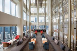 a large lobby with couches and chairs and windows at Crowne Plaza Shenzhen Nanshan, an IHG Hotel in Shenzhen