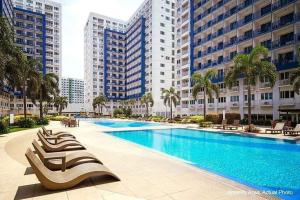 a large swimming pool in a city with tall buildings at LIAM's Staycation in Manila