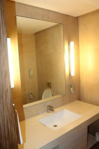 a bathroom with a sink and a large mirror at Pride Elite, Phaltan in Phaltan