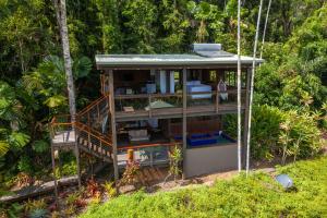 a tree house in the middle of a forest at Daintree Holiday Homes - La Vista in Cow Bay