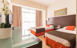 Cama o camas de una habitación en Hotel Adonis Pelinor