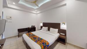 a hotel room with two beds and a television at The Cliff Edge calangute in Calangute