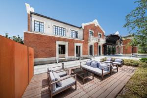 a patio with chairs and tables in front of a building at Melia Shanghai Parkside in Shanghai