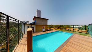 a swimming pool on the deck of a house at De Alcazar Calangute in Calangute