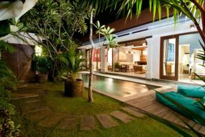 a villa with a swimming pool and a house at 2BR Villa Violetta - Minggu Villas in Kerobokan