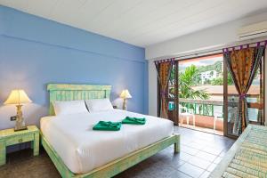 a bedroom with a large bed and a large window at Casa Brazil Homestay in Karon Beach