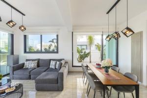 a living room with a couch and a table at Pernera Beach Villa in Protaras