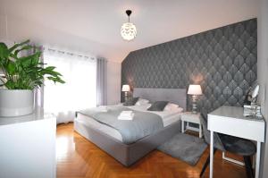 a bedroom with a large bed and a desk at Apartament Family First in Karpacz