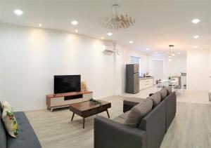a living room with a couch and a tv at Grace Homestay Tawau in Tawau