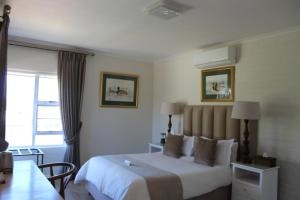 a hotel room with a bed and a window at Cinnamon House Bed & Breakfast in Cape Town +45 photos