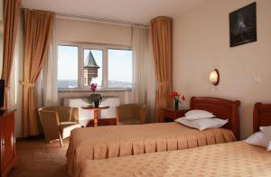 a hotel room with two beds and a window at Hotel Moldova in Iaşi +39 photos