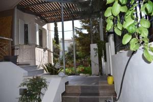 a porch of a house with stairs and plants at h2h Anthi Comfort apt near Athens in Athens