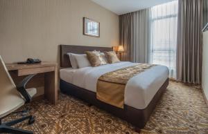 Postel nebo postele na pokoji v ubytování Marcian Garden Hotel