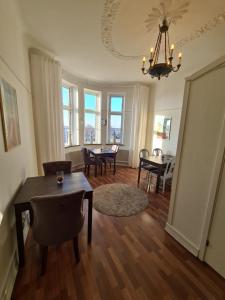 a living room with a table and chairs and a dining room at Hamnhotellet Kronan in Landskrona