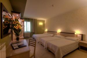 Кровать или кровати в номере Hotel Galileo