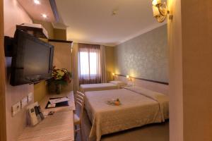 Krevet ili kreveti u jedinici u objektu Hotel Galileo