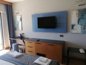 a bedroom with a bed and a television on the wall at Doğruer Boutique Hotel & Spa in Mugla
