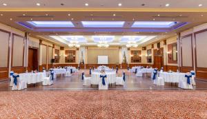 a banquet hall with white tables and blue bows at Radisson Hotel Kathmandu in Kathmandu +37 photos