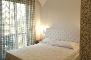 a bedroom with a bed and a large window at Abracadabra Tortona in Milan