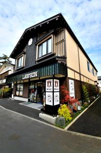 a black and white building with a store at Oyado Yukizumi in Kusatsu