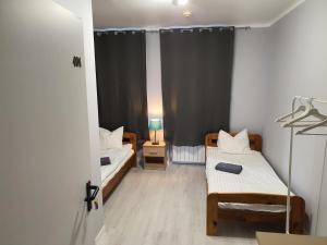 מיטה או מיטות בחדר ב-Jasna Hotelik