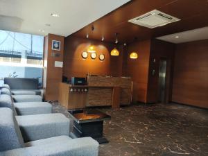 a lobby with a waiting room with chairs and a table at Hotel Vintage in Vadodara